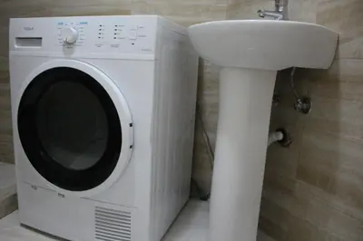 a washing machine next to a sink in a bathroom at Jovan Vukovic in Kotor