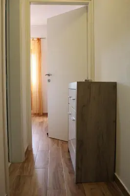 a room with a chest of drawers and a door at Jovan Vukovic in Kotor