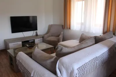 a living room with two couches and a flat screen tv at Jovan Vukovic in Kotor