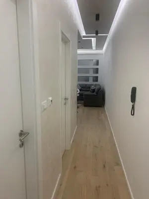 a hallway with a door and a couch in a room at Bar Exclusiv Soho city Residence in Bar