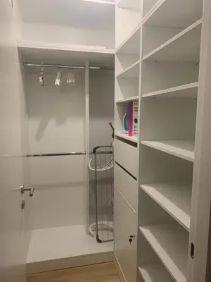 a walk in shower in a bathroom with white shelves at Bar Exclusiv Soho city Residence in Bar