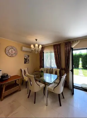 a dining room with a glass table and chairs at Villa Deluxe Lastva in Budva