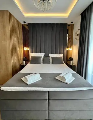 a bedroom with a large bed with two pillows on it at Casa Al Mare Residence Apartment Lena in Budva