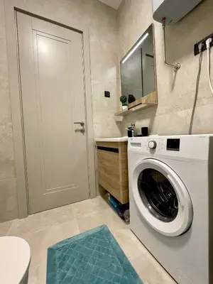 a laundry room with a washing machine and a mirror at Casa Al Mare Residence Apartment Lena in Budva