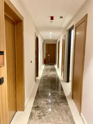 an empty corridor in a hotel with wooden doors at Casa Al Mare Residence Apartment Lena in Budva