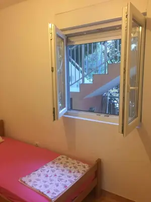 a small room with a window and a bed with a mat at Ruza vetrova in Bar
