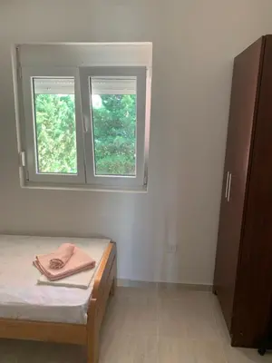 a bedroom with a bed and two windows at Ruza vetrova in Bar