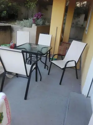 a glass table and chairs on a patio at Ruza vetrova in Bar