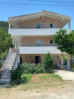 a house with a staircase in front of it at MD Apartmani Canj in Čanj
