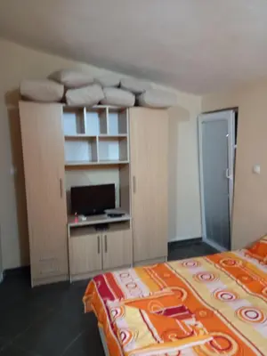 a bedroom with a bed and a desk with a tv at MD Apartmani Canj in Čanj