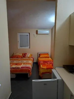 a room with two beds and a window in it at MD Apartmani Canj in Čanj