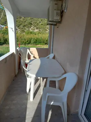 a white table and chairs on a balcony with a view at MD Apartmani Canj in Čanj