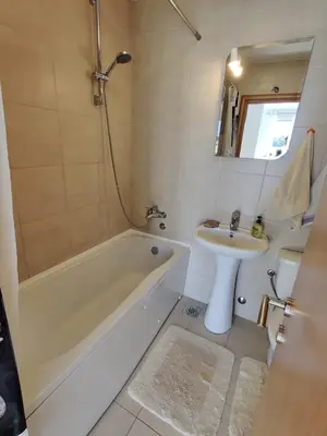 a bathroom with a tub and a sink and a bath tub at Good morning Petrovac in Petrovac na Moru