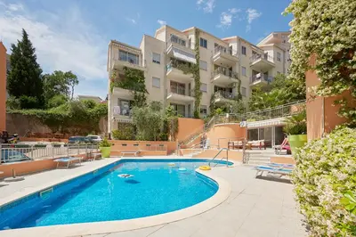 a swimming pool in front of a building at Good morning Petrovac in Petrovac na Moru
