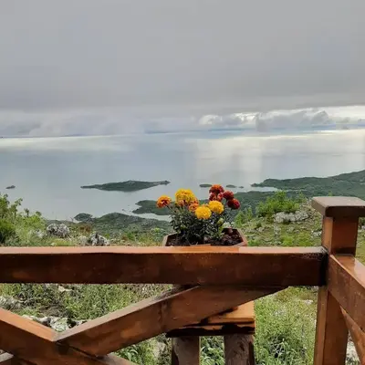 a wooden bench with flowers on top of it at Livari Rooms Exclusive Chalet in Bar