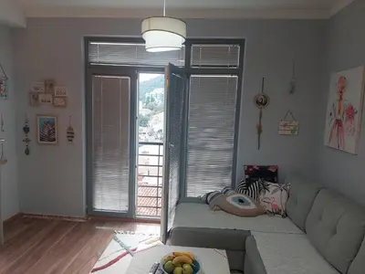 a living room with a couch and a large window at Apartment Anika in Becici