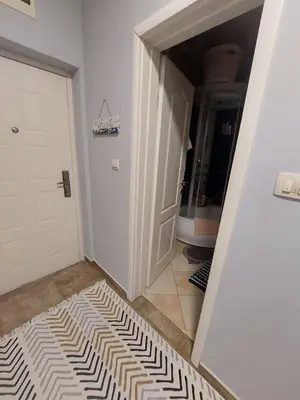 a hallway with a rug on the floor next to a door at Apartment Anika in Becici