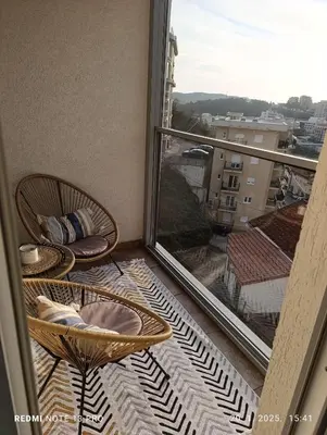 a balcony with chairs and a view of a city at Apartment Anika in Becici