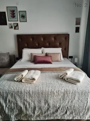 a bedroom with a bed with two towels on it at Apartman Rosemary in Sveti Stefan