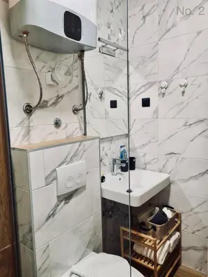 a bathroom with a toilet and a sink at Apartman Rosemary in Sveti Stefan