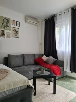 a living room with a couch and a table at Apartman Rosemary in Sveti Stefan