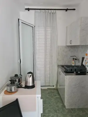 a kitchen with two pots and pans on a counter at Apartman Rosemary in Sveti Stefan