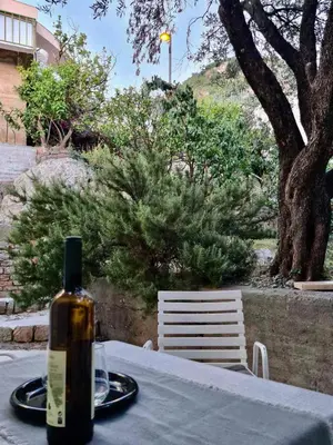 a bottle of wine sitting on top of a table at Apartman Rosemary in Sveti Stefan