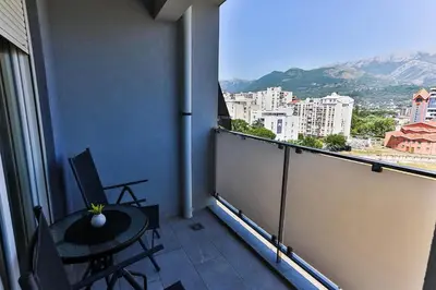 a balcony with a table and chairs on a balcony at Apartment Alex in Bar