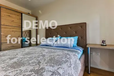 a bedroom with a bed and a sign that reads demmo forest section at Apartment Alex in Bar