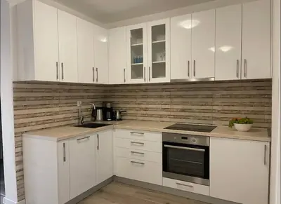 a kitchen with white cabinets and a stove top oven at Villa Roki in Ravanj