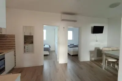 a white living room with a bedroom and a bed at Villa Roki in Ravanj