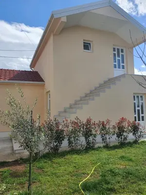 a house with stairs on the side of it at Apartman Tolosi in Podgorica