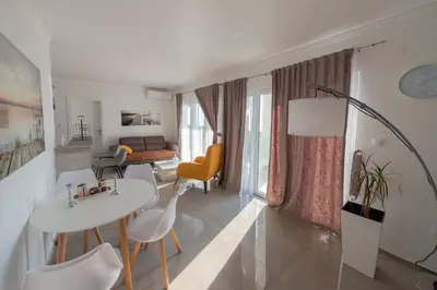 a living room with a white table and chairs at Villa Hacienda in Budva