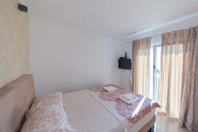a bedroom with a bed and a window at Villa Hacienda in Budva