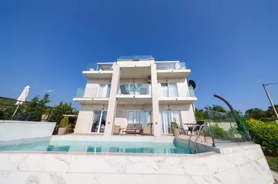 a house with a swimming pool in front of it at Villa Hacienda in Budva