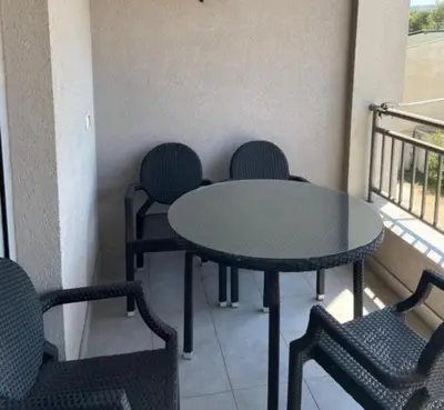 a table and chairs in a room with a balcony at Seaview Apartment in Bar