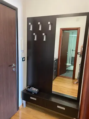 a bathroom with a large mirror on a black dresser at Seaview Apartment in Bar