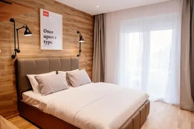 a bedroom with a bed and a window at Comfortable Apartment at CITY QUART in Podgorica