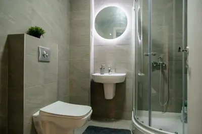 a bathroom with a toilet and a sink and a shower at Comfortable Apartment at CITY QUART in Podgorica