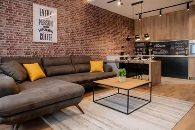 a living room with a couch and a table at Comfortable Apartment at CITY QUART in Podgorica