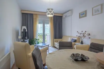 a living room with a table and a couch at Sunshine in Kotor