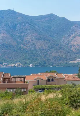 a group of houses with a lake in the background at Sunshine in Kotor