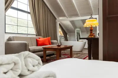 a hotel room with a bed and a living room at MASHTRA - The Olive House in Ulcinj