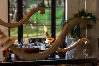 a dining room with a table and a chandelier at MASHTRA - The Olive House in Ulcinj