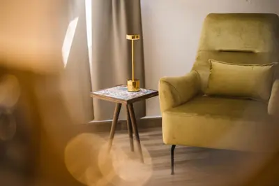 a side table with a chair and a lamp on it at MASHTRA - The Olive House in Ulcinj