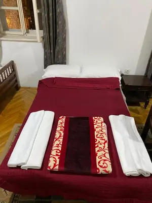 two beds with red and white blankets on them at VivaV in Budva