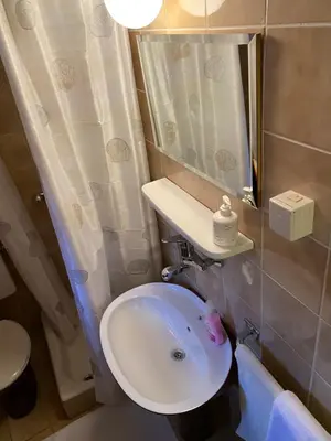a bathroom with a white sink and a mirror at VivaV in Budva
