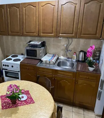 a small kitchen with a sink and a stove at VivaV in Budva