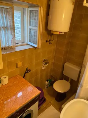 a small bathroom with a toilet and a sink at VivaV in Budva