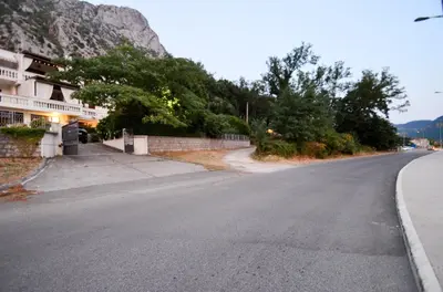 an empty street in front of a mountain at Djardin in Kotor